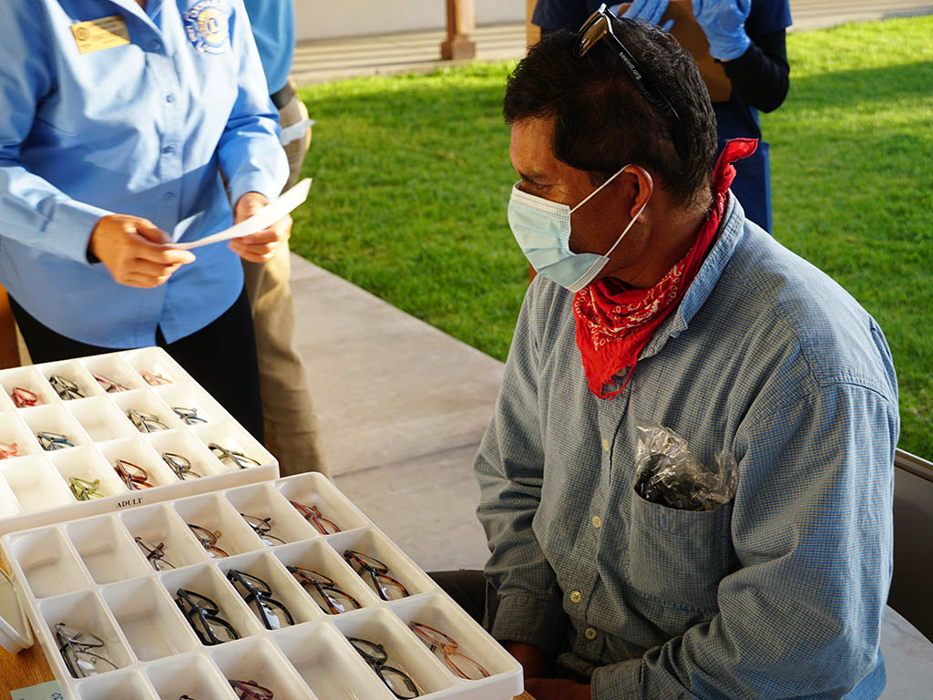 Man looking at different eye glasses options offered by SEE Vision Care.