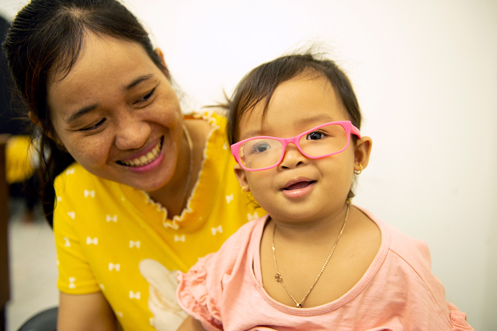 Young girl in pink glasses being treated for Strabismus